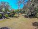 View of the spacious yard with a brick fire pit and gardening area at 12303 Greenland Dr, Riverview, FL 33579