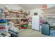 Barn interior showing wooden shelves with storage bins, boxes and a refrigerator at 12303 Greenland Dr, Riverview, FL 33579