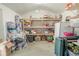 Barn interior showing wooden shelves with storage bins, boxes and a refrigerator at 12303 Greenland Dr, Riverview, FL 33579