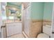 Bathroom featuring a shower, toilet and single sink vanity with granite countertop at 12303 Greenland Dr, Riverview, FL 33579