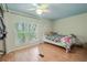 Bedroom with a window view, ceiling fan, and light wood floors; a cozy and inviting space at 12303 Greenland Dr, Riverview, FL 33579