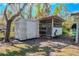View of the backyard chicken coop and equipment shed under a clear blue sky at 12303 Greenland Dr, Riverview, FL 33579