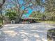 Sprawling home with large concrete pad, mature trees and covered patio area at 12303 Greenland Dr, Riverview, FL 33579