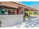 Side exterior featuring a covered patio with outdoor kitchen and a red entry door at 12303 Greenland Dr, Riverview, FL 33579