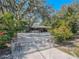 Gated property featuring lush landscaping and a charming single-story home at 12303 Greenland Dr, Riverview, FL 33579
