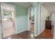 An interior hallway with views to a bathroom and bedroom at 12303 Greenland Dr, Riverview, FL 33579