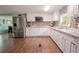 Updated kitchen with stainless steel appliances, granite countertops, and mosaic tile backsplash at 12303 Greenland Dr, Riverview, FL 33579