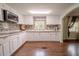 Updated kitchen features stainless appliances, white cabinets and stone countertops at 12303 Greenland Dr, Riverview, FL 33579