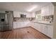 Bright kitchen features stainless steel refrigerator, white cabinets and a tiled backsplash at 12303 Greenland Dr, Riverview, FL 33579