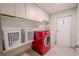 Laundry room with washer, dryer and white cabinets at 12303 Greenland Dr, Riverview, FL 33579