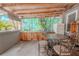 Covered outdoor kitchen with rustic wood cabinets, stainless steel appliances, and an adjacent dining area at 12303 Greenland Dr, Riverview, FL 33579