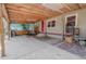 Outdoor kitchen and dining space with red door and exposed wood roof at 12303 Greenland Dr, Riverview, FL 33579