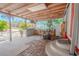 Side exterior featuring a covered patio with outdoor kitchen and a red entry door at 12303 Greenland Dr, Riverview, FL 33579