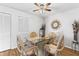 Inviting dining room area with a glass table, decorative accents, laminated floors, and a ceiling fan at 12406 Eagleswood Dr # C, Hudson, FL 34667