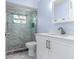 Updated bathroom with walk-in shower, modern vanity, and neutral color palette at 1489 Dundee Dr, Palm Harbor, FL 34684