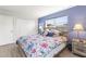 Cozy bedroom featuring a floral comforter, wood-look floor, and natural light at 1489 Dundee Dr, Palm Harbor, FL 34684