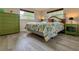 Comfortable bedroom with green decor, side tables, and a view of the outdoors at 1489 Dundee Dr, Palm Harbor, FL 34684