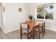 Bright dining room featuring wood flooring and a large window, creating a welcoming atmosphere at 1489 Dundee Dr, Palm Harbor, FL 34684