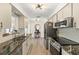 Modern kitchen featuring stainless steel appliances, granite counters, and updated fixtures at 1489 Dundee Dr, Palm Harbor, FL 34684