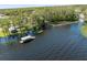 Breathtaking aerial view of a lake showcasing multiple docks, beautiful trees, and waterfront scenery at 1489 Dundee Dr, Palm Harbor, FL 34684