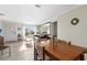 Inviting living room with ample sunlight, a dining table, and a leather sofa at 1489 Dundee Dr, Palm Harbor, FL 34684