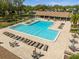 View of a stunning community pool with ample lounge chairs and seating areas at 1489 Dundee Dr, Palm Harbor, FL 34684
