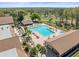 Stunning aerial view of the community pool area, surrounded by palm trees at 1489 Dundee Dr, Palm Harbor, FL 34684