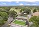 Aerial view of shuffleboard courts, offering recreational activities in a serene, wooded setting at 1489 Dundee Dr, Palm Harbor, FL 34684