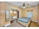 Inviting bedroom with wood paneled walls and a ceiling fan at 15 Shore Dr, Palm Harbor, FL 34683