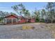 Side and rear exterior view of a single-Gathering home with a gravel driveway at 15 Shore Dr, Palm Harbor, FL 34683