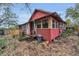 Exterior view of red house with steps leading to entrance at 15 Shore Dr, Palm Harbor, FL 34683