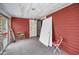 Enclosed porch with red wood walls, simple ceiling light, and miscellaneous items at 15 Shore Dr, Palm Harbor, FL 34683