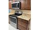 Well-maintained kitchen featuring stainless steel appliances, granite countertops, and wood cabinetry at 1601 43Rd N St # 226, St Petersburg, FL 33713