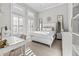 Bright bedroom with plantation shutters, white furniture, chandelier and decorator accents at 16312 Palmettoglen Ct, Lithia, FL 33547