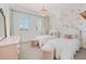 Bedroom showcasing twin beds, floral wallpaper, window and neutral carpet at 16312 Palmettoglen Ct, Lithia, FL 33547