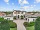 Stately two-story house with symmetrical landscaping, brick driveway, and attached two-car garage at 16312 Palmettoglen Ct, Lithia, FL 33547