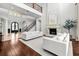 Grand living room featuring a stone fireplace, wrought-iron staircase, hardwood floors, and elegant decor at 16312 Palmettoglen Ct, Lithia, FL 33547