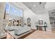 Bright living room featuring tall ceilings, fireplace, hardwood floors, and natural light from the large windows at 16312 Palmettoglen Ct, Lithia, FL 33547