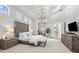 This primary bedroom features coffered ceiling, a chandelier and double doors at 16312 Palmettoglen Ct, Lithia, FL 33547