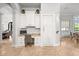 A home office with built-in white cabinetry, granite counters, and travertine floors at 16312 Palmettoglen Ct, Lithia, FL 33547