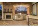This luxurious outdoor kitchen features a stone fireplace, built-in grill, granite counters and is perfect for entertaining at 16312 Palmettoglen Ct, Lithia, FL 33547