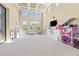 Spacious playroom featuring a variety of toys, bright natural light, and high ceilings at 16312 Palmettoglen Ct, Lithia, FL 33547