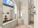 Shower area featuring neutral stone, a built in seat, and a garden view at 16312 Palmettoglen Ct, Lithia, FL 33547