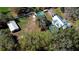 Aerial view of a home with a large yard, detached garage, pool, and lush greenery, perfect for outdoor living at 16349 Spring Valley Rd, Dade City, FL 33523