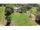Expansive property featuring a well-maintained lawn, mature trees, and outbuildings at 16349 Spring Valley Rd, Dade City, FL 33523