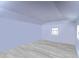 A bedroom with simple, light blue-painted walls and light wood flooring at 16349 Spring Valley Rd, Dade City, FL 33523