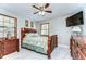Cozy bedroom featuring a bed with decorative bedding, a ceiling fan, and natural light from the windows at 16349 Spring Valley Rd, Dade City, FL 33523