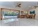Bright dining area with a pool view, marble floors, ceiling fan and elegant decor at 16349 Spring Valley Rd, Dade City, FL 33523