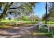 Long gravel driveway leading to a beautiful estate through a white fence at 16349 Spring Valley Rd, Dade City, FL 33523