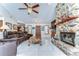 Elegant living room with stone fireplace, leather furniture, and marble floors at 16349 Spring Valley Rd, Dade City, FL 33523